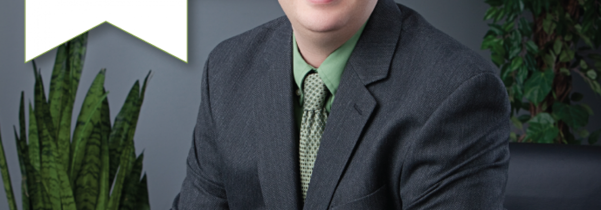 Headshot of Aaron McEwin with a white banner at the top right reading "NGBS Legacy Partner."